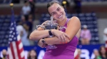 Aryna Sabalenka, of Belarus, hugs the trophy after winning the women's singles final of the U.S. Open tennis championships against Jessica Pegula, of the United States, Saturday, Sept. 7, 2024, in New York. (AP Photo/Frank Franklin II)