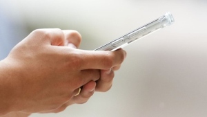 A person uses a cellphone in Ottawa on Monday, July 18, 2022. THE CANADIAN PRESS/Sean Kilpatrick
