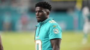 Miami Dolphins wide receiver Tyreek Hill watches from the sideline during the second half of a preseason NFL football game against the Washington Commanders, Saturday, Aug. 17, 2024, in Miami Gardens, Fla. (AP Photo/Wilfredo Lee)
