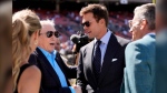 Tom Brady watches warmups before a preseason NFL football game between the Dallas Cowboys and Los Angeles Rams, Sunday, Aug. 11, 2024, in Inglewood, Calif. (AP Photo/Gregory Bull)