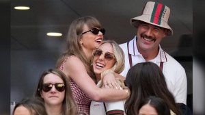 Taylor swift, left, hugs Brittany Mahomes as Travis Kelce looks on during the men's singles final between Jannik Sinner, of Italy, and Taylor Fritz, of the United States, at the U.S. Open tennis championships, Sunday, Sept. 8, 2024, in New York. (AP Photo/Kirsty Wigglesworth)