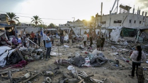 Palestinians inspect the damage at a tent area in the courtyard of Al Aqsa Martyrs hospital, hit by an Israeli bombardment on Deir al-Balah, central Gaza Strip, Thursday, Sept. 5, 2024. (AP Photo/Abdel Kareem Hana)