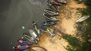 Fishing boats sit on the shore of the Paraguay River in Mariano Roque Alonso, Paraguay, Monday, Sept. 9, 2024. Water levels have plunged to their lowest-ever level amid a drought, according to Paraguay's Meteorology and Hydrology Office. (AP Photo/Jorge Saenz)