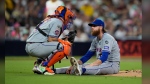 New York Mets starting pitcher Paul Blackburn, right, talks to catcher Francisco Alvarez after getting hit by a line out by San Diego Padres' David Peralta during the third inning of a baseball game Friday, Aug. 23, 2024, in San Diego. (AP Photo/Gregory Bull)