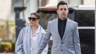 Canadian musician Jacob Hoggard arrives alongside his wife Rebekah Asselstine, for his sex assault trial at the Toronto courthouse on Tuesday, May 10, 2022 in Toronto. Hoggard is expected to seek bail at a court hearing today, weeks after beginning his sentence for a sexual assault conviction. THE CANADIAN PRESS/Cole Burston
