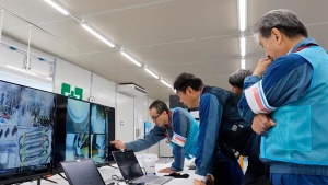 In this photo released by Tokyo Electric Power Company Holdings (TEPCO), TEPCO executives observe plant officials making final procedural checks from an operation room to monitor and remote control an extendable robot, at Fukjushima Daiichi nuclear power plant in Okuma, Fukushima prefecture, northern Japan Monday, Sept. 9, 2024. (Tokyo Electric Power Company Holdings via AP)