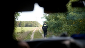 Federal police officer Frank Malack patrols during a search for migrants crossing illegally at the border from Poland into Germany in a forest near Forst southeast of Berlin, Germany, Oct. 11, 2023. (AP Photo/Markus Schreiber)