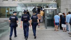 Police officers walk in the Avignon courthouse prior to the trial of Dominique Pelicot, in Avignon, southern France, Sept. 5, 2024. (AP Photo/Lewis Joly)