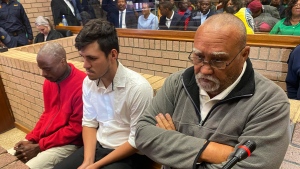 Three men accused of killing two women and feeding their bodies to pigs, from right to left, farm-owner, Zachariah Olivier, supervisor, Adrian Rudolph de Wet and employee, William Musora appear in court Polokwane, South Africa, Tuesday, Sept. 10, 2024. (AP Photo)