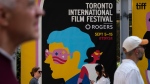 People walk by a Toronto International Film Festival sign on the opening day of the 49th TIFF in Toronto on Thursday, Sept. 5, 2024. THE CANADIAN PRESS/Paige Taylor White