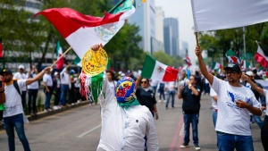 Judicial workers, one wearing a 'lucha libre' wrestling mask, protest the government's proposed judicial reform, outside the Senate in Mexico City, Tuesday, Sept. 10, 2024. (Eduardo Verdugo / AP Photo)