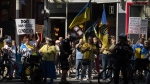 People protest outside of Scotiabank Theatre about the documentary "Russians at War" playing at the Toronto International Film Festival, in Toronto, on Tuesday Sept. 10, 2024. THE CANADIAN PRESS/Paige Taylor White