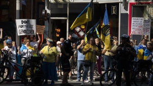 People protest outside of Scotiabank Theatre about the documentary "Russians at War" playing at the Toronto International Film Festival, in Toronto, on Tuesday Sept. 10, 2024. THE CANADIAN PRESS/Paige Taylor White