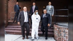 Tyrese Haspil is escorted out of the 7th precinct by NYPD detectives, July 17, 2020, in New York. (AP Photo/Eduardo Munoz Alvarez, File)