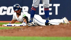 Toronto Blue Jays second baseman Davis Schneider (36) slides safely into third base with a triple against the New York Mets during fourth inning MLB baseball action in Toronto on Tuesday Sept. 10, 2024. THE CANADIAN PRESS/Jon Blacker