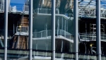 A new condo construction site is reflected in the window on an ongoing condo construction site in downtown Toronto on Thursday, May 25, 2023. THE CANADIAN PRESS/Chris Young