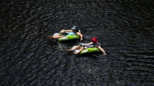 People float in the Madawaska River in Renfrew County, Ont., on July 8, 2024. The Weather Network predicts that Canadians will see a slow transition into autumn as temperatures in most regions are expected to be above normal in the coming weeks. THE CANADIAN PRESS/Sean Kilpatrick