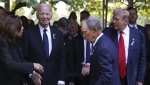 Vice President Kamala Harris, far left, greets former President Donald Trump, far right, as President Joe Biden and Michael Bloomberg look on upon arriving for the 9/11 Memorial ceremony on Wednesday, Sept. 11, 2024, in New York. (AP Photo/Yuki Iwamura)