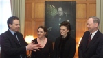 British Prime Minister Tony Blair explains how Canadian photographer Yousef Karsh made the stern portrait of Sir Winston Churchill in the Speaker's Chambers on Parliament Hill in Ottawa, Thursday, February 22, 2001. From left to right are Prime Minister Tony Blair, Aline Chretien, wife of Prime Minister Jean Chretien, Cherie Booth, wife of Prime Minister Blair and Prime Minister Jean Chretien. THE CANADIAN PRESS/Fred Chartrand