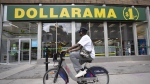 Dollarama Inc. reported a second-quarter profit of $285.9 million, up from $245.8 million in the same quarter last year as its sales rose 7.4 per cent.A person cycles past a Dollarama store in Montreal, Wednesday, June 7, 2023. THE CANADIAN PRESS/Christinne Muschi