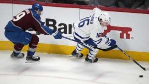 Toronto Maple Leafs right wing Mitch Marner, right, picks up the puck as Colorado Avalanche centre Nathan MacKinnon defends in the first period of an NHL hockey game Saturday, Dec. 31, 2022, in Denver. MacKinnon got his first up-close look at Mitch Marner back in 2017. THE CANADIAN PRESS/AP/David Zalubowski