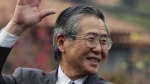 Former Peru president Alberto Fujimori waves at his home in Santiago after leaving the academy for the training of corrections officers in Santiago, Chile, May 18, 2006. (Claudio Santana/AP Photo)