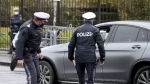 Police officers check a car in downtown Vienna, Austria, Friday, Oct. 30, 2020. (AP Photo/Ronald Zak, File)