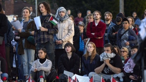 Attendees listen to speakers during a vigil on Alki Beach for the death of 26-year old Aysenur Ezgi Eygi, killed recently in the occupied West Bank, Sept. 11, 2024, in Seattle. (AP Photo/John Froschauer)