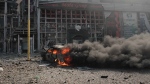 A car burns in front of a business centre damaged after twin Russian bombings in Kharkiv, Ukraine, Sunday Sept. 1, 2024. (AP Photo/George Ivanchenko)