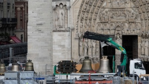 A truck carrying bells is parked outside Notre-Dame de Paris cathedral, in Paris, Thursday, Sept. 12, 2024. The Cathedral is getting its bells back, just in time for the medieval landmark's reopening following a devastating 2019 fire. (AP Photo/Michel Euler)