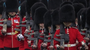 Soldiers from the Irish Guards march along the Mall as they take part in the Trooping the Color ceremony, in London, Saturday, June 15, 2024. (AP Photo/Alberto Pezzali, File)