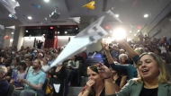 People in the audience throw paper airplanes toward the stage during a performance at the Ig Nobel Prize ceremony at Massachusetts Institute of Technology in Cambridge, Mass., Thursday, Sept. 12, 2024. (AP Photo/Steven Senne)