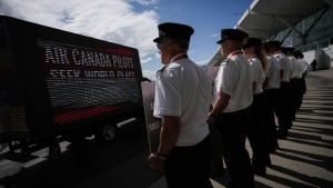 Air Canada pilots stand during an informational picket at Vancouver International Airport in Richmond, B.C., Tuesday, Aug. 27, 2024. THE CANADIAN PRESS/Darryl Dyck