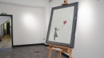 A Banksy painting, Girl With Balloon, on display at the Grove Gallery in London after it was stolen on Sunday, then recovered and returned to the gallery, Friday Sept. 13, 2024. (James Manning/PA via AP)