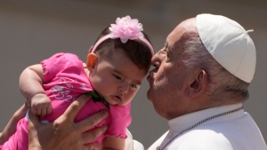 Pope Francis kisses a baby at the end of the weekly general audience in St.Peter's Square at the Vatican, Wednesday, May 29, 2024. (Gregorio Borgia / AP Photo)