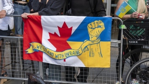 People protest outside of the Scotiabank Theatre about the documentary "Russians at War" at the Toronto International Film Festival, in Toronto, on Tuesday Sept. 10, 2024. (The Canadian PressS/Paige Taylor White)