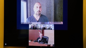 Sean M. Higgins, top, the alleged drunken driver charged with killing NHL hockey player Johnny Gaudreau and his brother Matthew as they bicycled on a rural road, appears before Judge Michael Silvanio, bottom, for his hearing via video from jail, Friday, Sept. 13, 2024, in Woodbury, N.J. (AP Photo/Derik Hamilton)