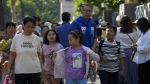 People pick up their children after school in Beijing, Friday, Sept. 13, 2024. (AP Photo/Andy Wong)