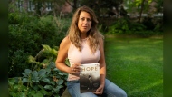 Barbara Adhiya, poses for a photo with her latest book titled, "Hope by Terry Fox" in Toronto on Sept. 13. THE CANADIAN PRESS/Paige Taylor White