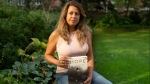 Barbara Adhiya, poses for a photo with her latest book titled, "Hope by Terry Fox" in Toronto on Sept. 13. THE CANADIAN PRESS/Paige Taylor White