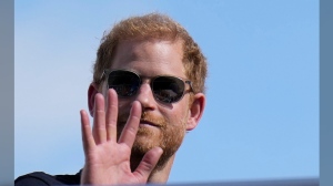 FILE - Britain's Prince Harry, the Duke of Sussex, waves during the Formula One U.S. Grand Prix auto race at Circuit of the Americas, on Oct. 22, 2023, in Austin, Texas. (AP Photo/Nick Didlick, File)