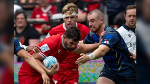 Canada's Lucas Rumball, left, pushes Japan's Tiennan Costley, right, during the second half of Pacific Nations Cup rugby, in Vancouver, on Sunday, August. 25, 2024. THE CANADIAN PRESS/Ethan Cairns