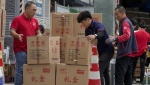 Workers load and pack gift boxes for the upcoming Mid-Autumn Festival, outside a supermarket in Beijing on Sept. 11, 2024. (Andy Wong/AP Photo)
