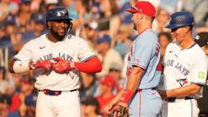 Toronto Blue Jays' Vladimir Guerrero Jr. (27) smiles towards St. Louis Cardinals first base Paul Goldschmidt (46) after hitting an RBI single during seventh inning MLB baseball action in Toronto on Saturday, September 14, 2024. THE CANADIAN PRESS/Chris Young