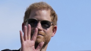 FILE - Britain's Prince Harry, the Duke of Sussex, waves during the Formula One U.S. Grand Prix auto race at Circuit of the Americas, on Oct. 22, 2023, in Austin, Texas. (AP Photo/Nick Didlick, File)
