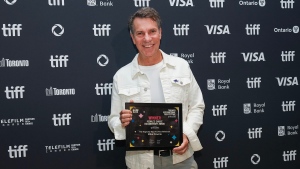 Mike Downie poses for photograph after winning 2024 People's Choice Awards for documentary called "The Tragically Hip: No Dress Rehearsal" during the Toronto International Film Festival awards ceremony in Toronto on Sunday, September 15, 2024. THE CANADIAN PRESS/Nathan Denette