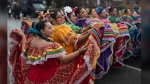 FILE - Members of the Cathedral City High School Ballet Folklorico pose for photo prior to joining in the Kingdom Day Parade in Los Angeles, Jan. 16, 2023. (AP Photo/Richard Vogel, File)