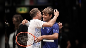 Italy's Flavio Cobolli celebrates with Italy team captain Filippo Volandri, left, after beating Netherlands' Tallon Griekspoor during a Davis Cup tennis match, at the Unipol Arena, in Bologna, Italy, Sunday, Sept. 15, 2024. (Massimo Paolone/LaPresse via AP)