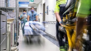 Hospital workers roll patients down a corridor at a hospital in Toronto in this undated photo. An AI early-warning system that predicts which patients are at risk of deteriorating while in hospital was associated with a decrease in unexpected deaths, a new study says. THE CANADIAN PRESS/HO Unity Health Toronto.