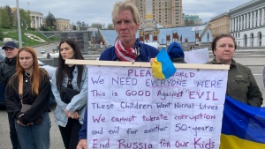 Ryan Wesley Routh holds up a banner during a rally in central Kyiv, Ukraine on Saturday April 30, 2022. (AP Photo/Alex Babenko)
